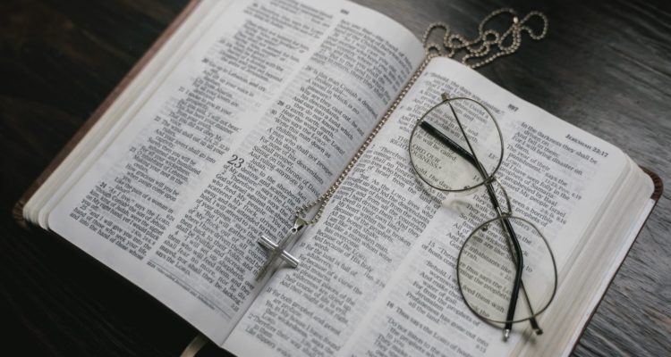 black framed eyeglasses on white book page